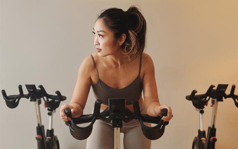 a woman riding a stationary bike