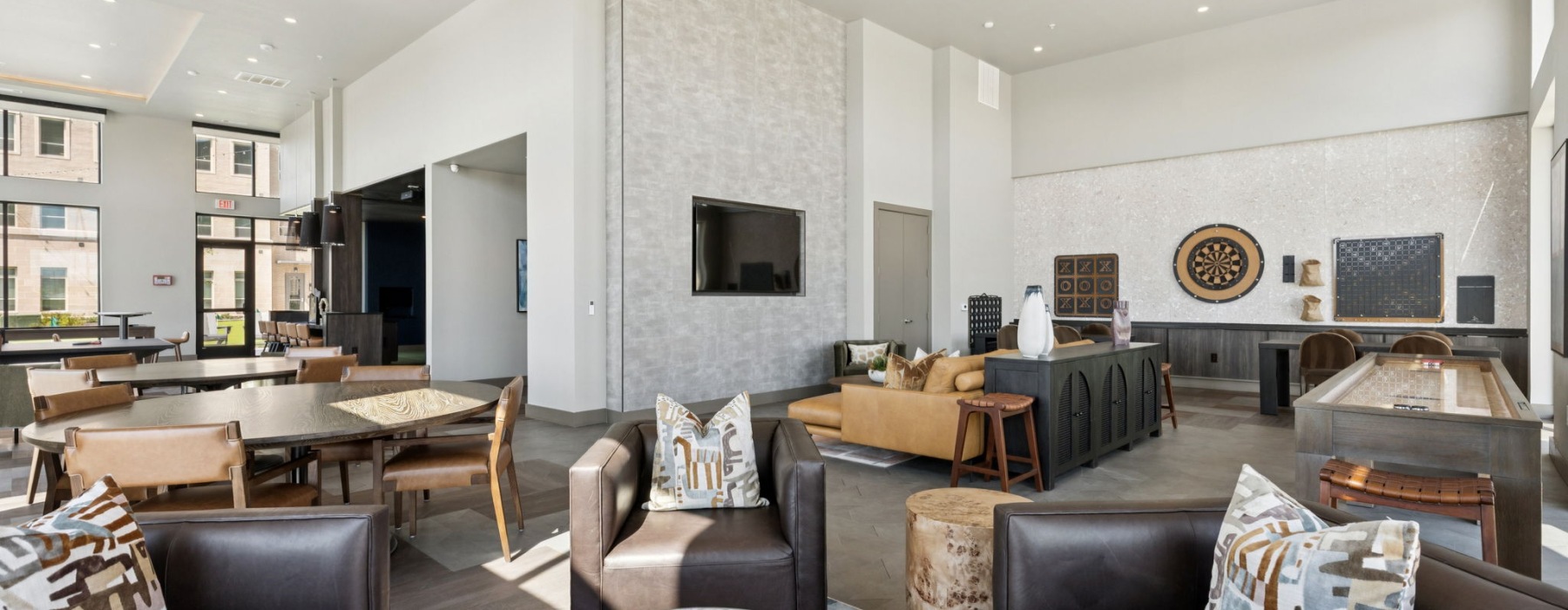 game lounge with seating and TVs