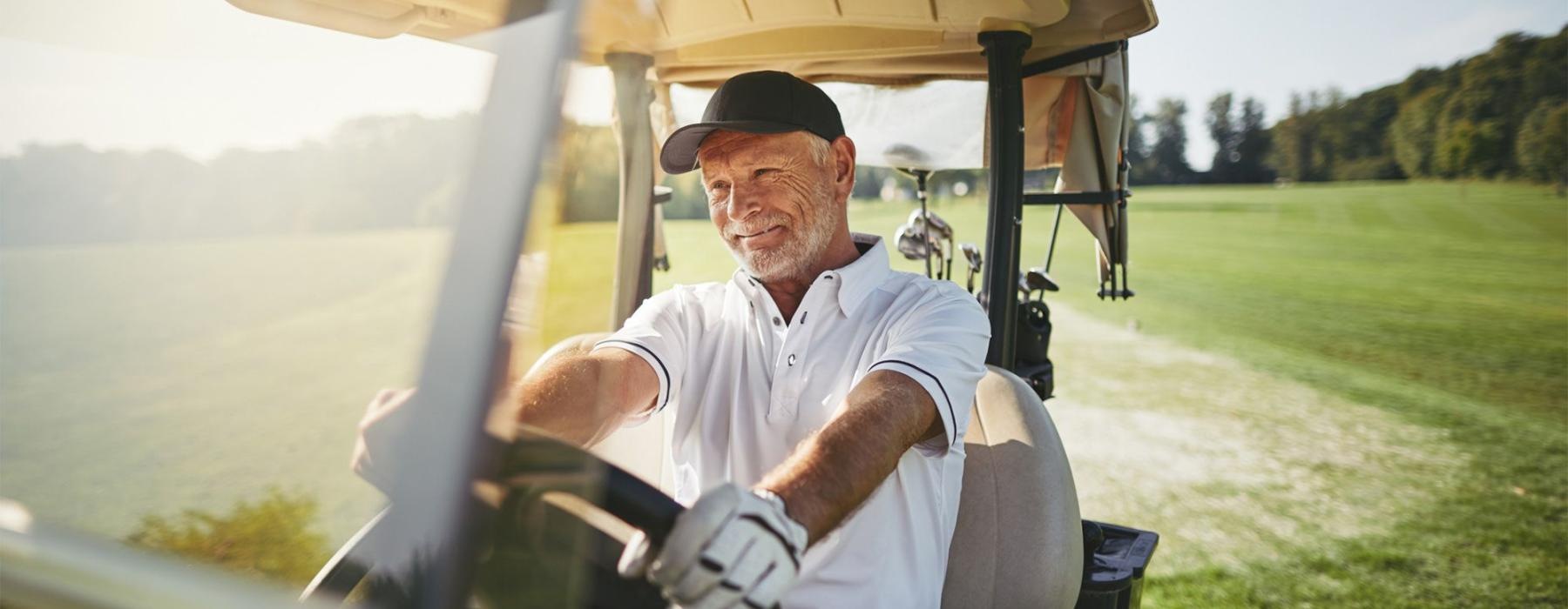 a man driving a golf cart