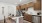 Kitchen with island, custom cabinetry, and stainless steel appliances