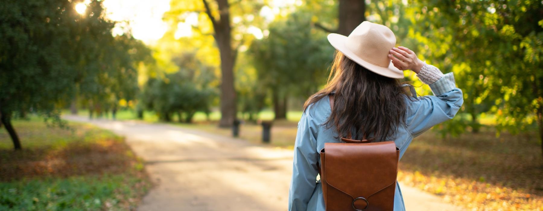 woman walking down a park path